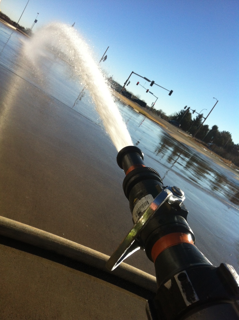 Fire hose nozzle firing stream of
                            water